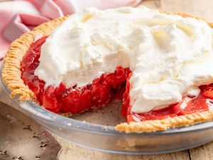fresh strawberry pie with a slice cut out