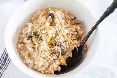 Risotto with Mushrooms - white bowls filed creamy mushroom risotto