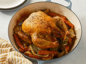 Roasted chicken over vegetable in a braiser