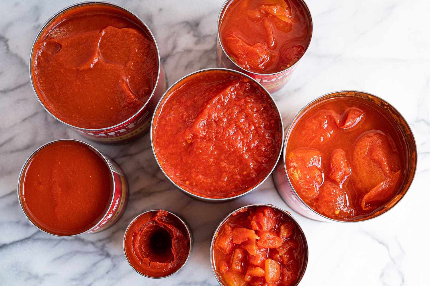 7 open cans of tomatoes