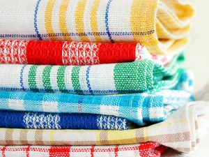 Stack of folded kitchen towels with different patterns