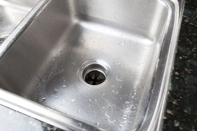 Stainless steel sink with a garbage disposal