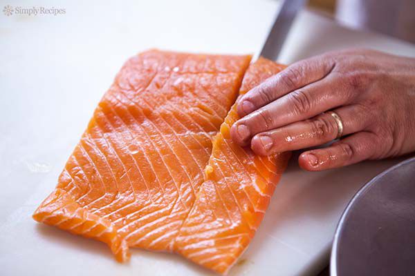 filleting the salmon on cutting board