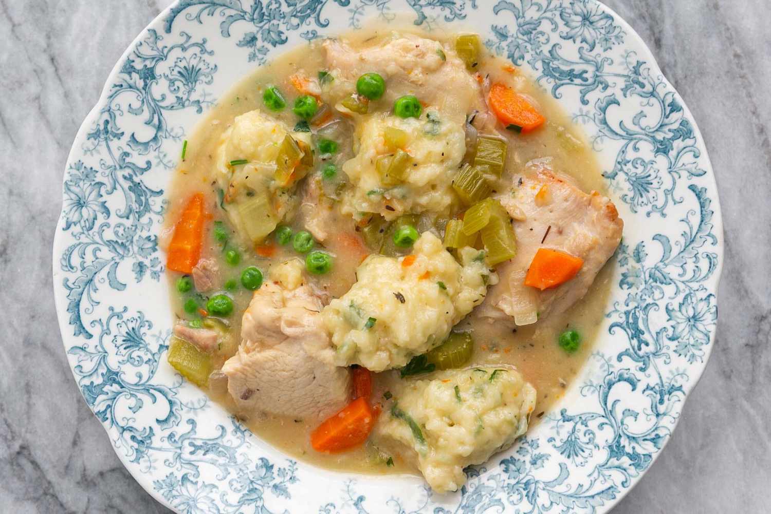 A plate of chicken and dumplings ready to serve