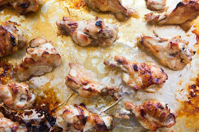 ginger honey chicken wings on baking sheet