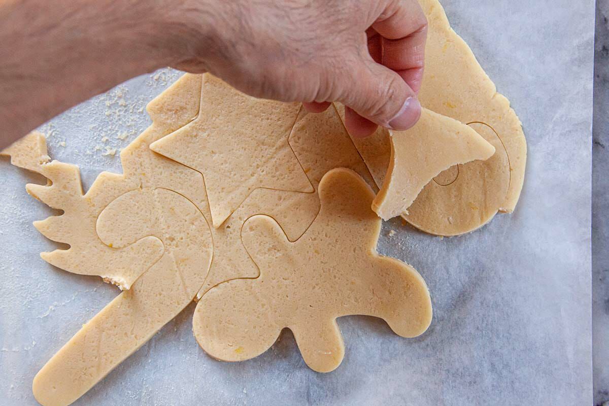 Removing excess dough from around the Cut Out Sugar Cookies before baking.
