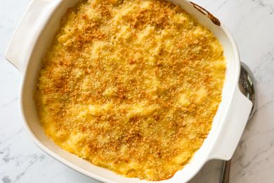 Overhead view of a baking dish of macaroni and cheese on a marble countertop