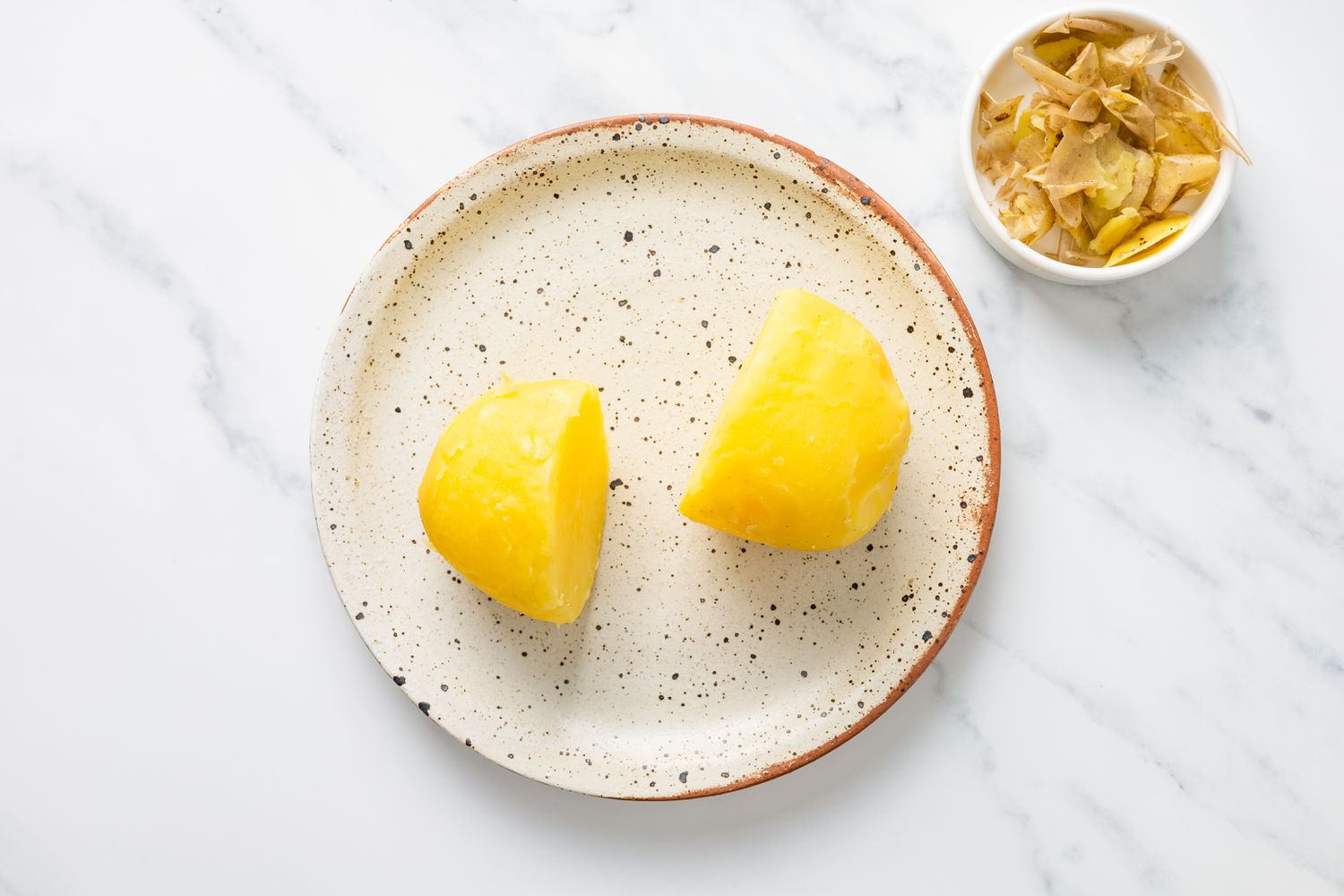 Peeled, cooked potatoes on a plate for potato candy recipe