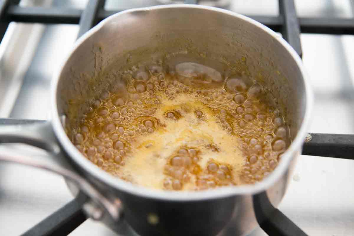 boiling the glaze for a fresh berry tart