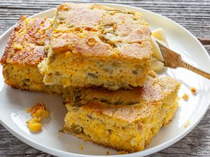 Pieces of Green Chile Corn Bread Recipe on Plate with Butter