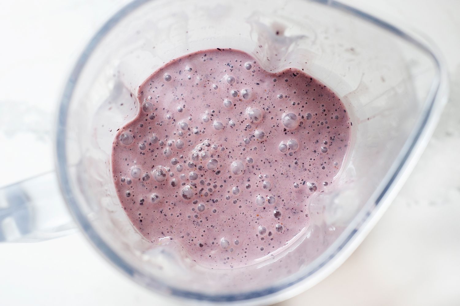 Basic blueberry smoothie recipe blended in a blender.