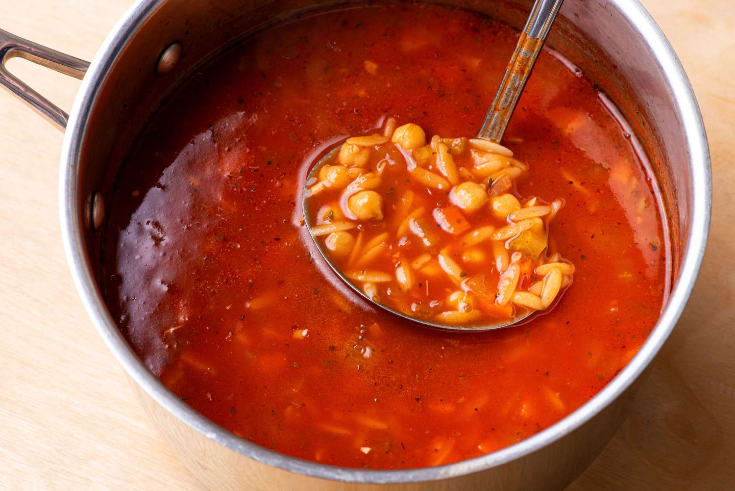 pot of 20-Minute Tomato Orzo Soup with a ladel
