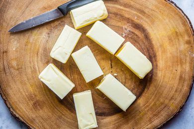 Ghee Clarified Butter Recipe - sticks of butter on wooden platter