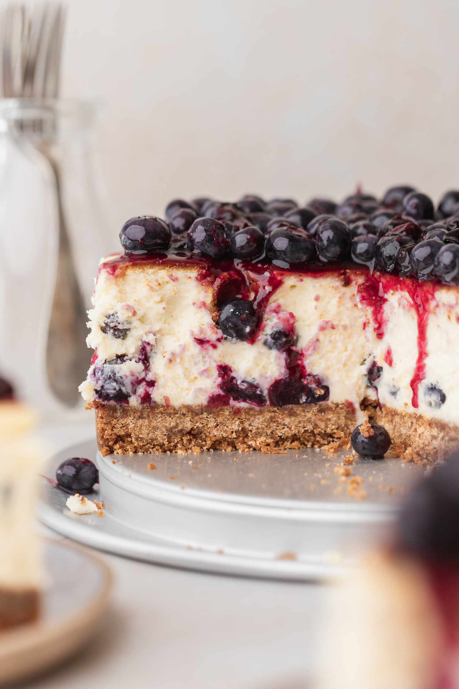Side view of a sliced blueberry cheesecake.
