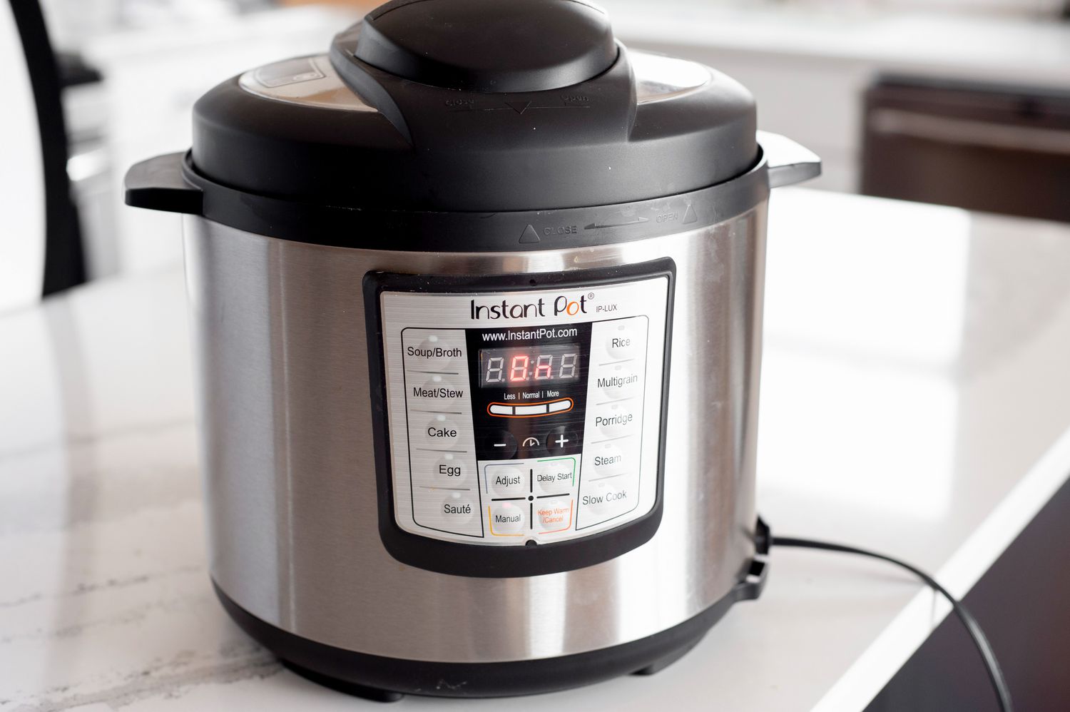 On the Counter, the Instant Pot Is Turned On 