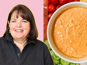 Ina Garten alongside a bowl of dip and a variety of vegetables