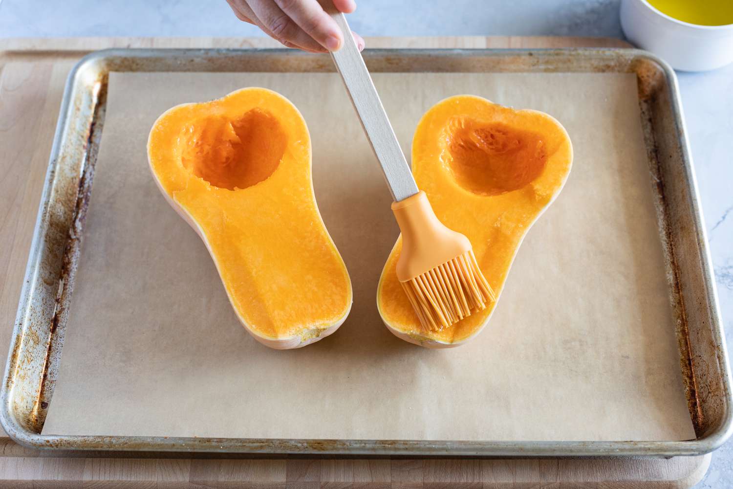 Brush butternut squash halves with oil before roasting