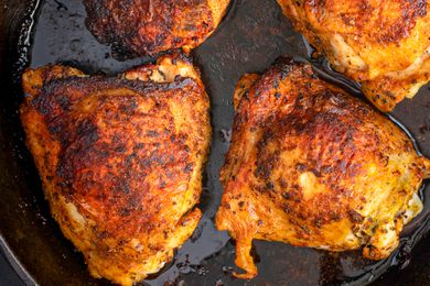 Chicken thighs on on a cast iron skillet