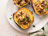 Overhead view of three vegetarian stuffed squash on a platter.