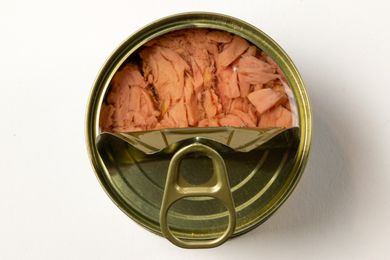 Opened can of tuna with visible fish chunks and pull-tab lid